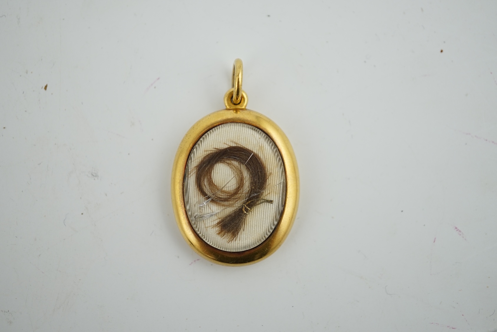 A yellow metal locket containing a lock of Napoleon I hair